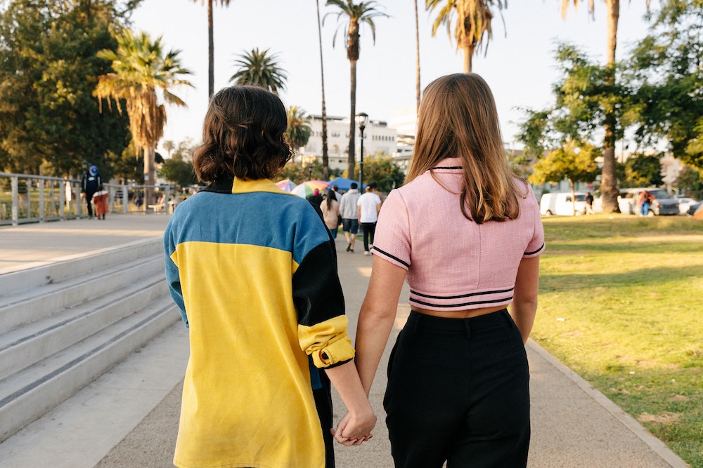 Photo of couple holding hands.