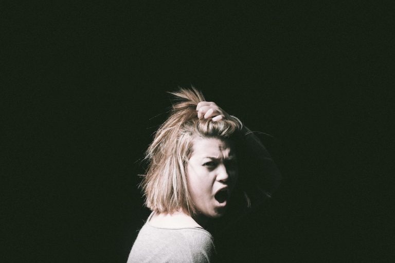 Woman pulling hair and screaming